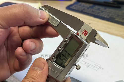 Digital caliper measuring a critical dimension of a custom metal part-4 Digital caliper measuring a critical dimension of a custom metal part-4