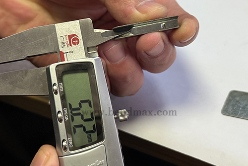 Digital caliper measuring a critical dimension of a custom metal part-1 Digital caliper measuring a critical dimension of a custom metal part-1